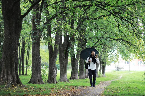 Giovane Con Gli Occhiali Cammina Nel Parco Con Ombrello Sotto — Foto Stock