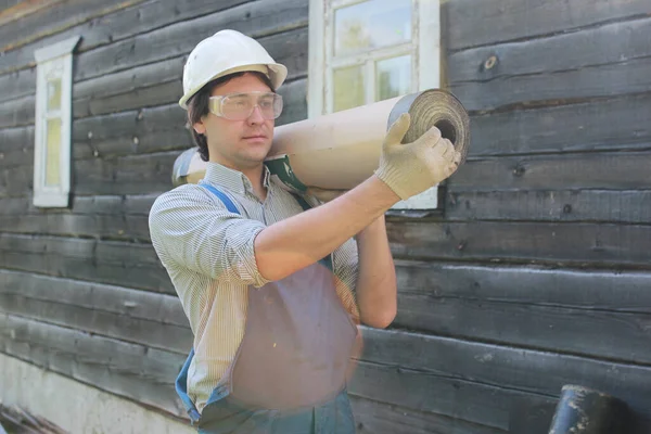 a man in the form of a builder repairs a house