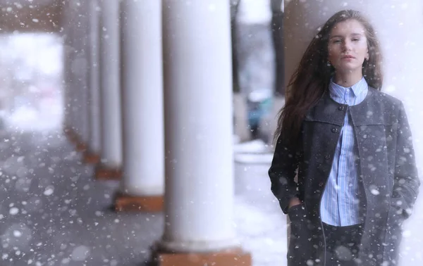 Young girl outdoors in winter. Model girl posing outdoors on a winter day. Festive weekend in the street walking girl