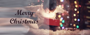 Noel arifesinde aile şöminede. Çocuklar Noel hediyelerini açıyor. Noel ağacının altında hediye kutularıyla çocuklar. Geleneksel şöminesi olan dekore edilmiş oturma odası. Sıcak bir kış akşamı evi..