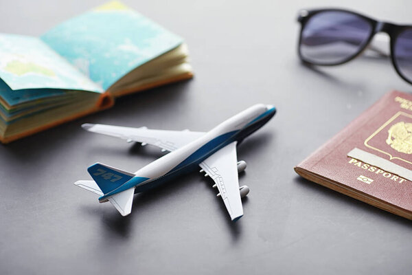 Travel concept. Tourist accessories gather in flight. Alcohol, camera, map items.