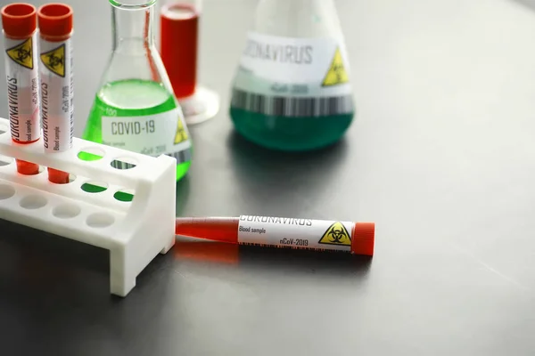 A blood sample for testing the dangerous virus coronavirus in body. Test tubes with tests for coronavirus. Laboratory studies of viral diseases.