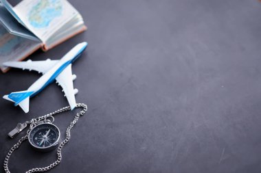 Seyahat konsepti. Elinde manyetik pusula var. El haritasında ve uçak arka planında Retro navigatör. Macera Arkaplanı.