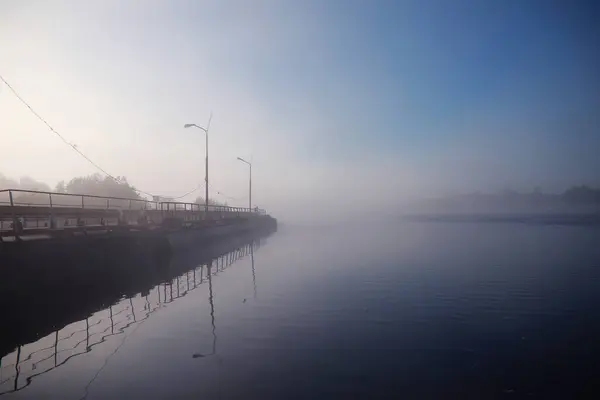 Fog in the lake. Morning nature water and white fog.