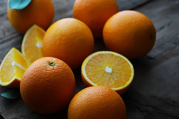 Orange citrus fruit on stone table. Orange background.