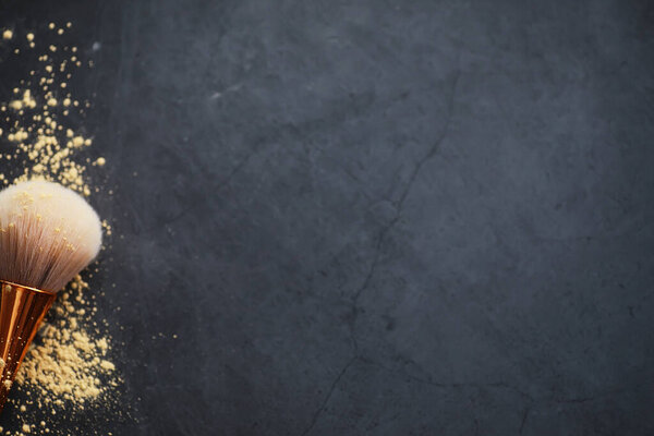 Powder and makeup brush. Brown powder on background. Makeup products. Style concept.