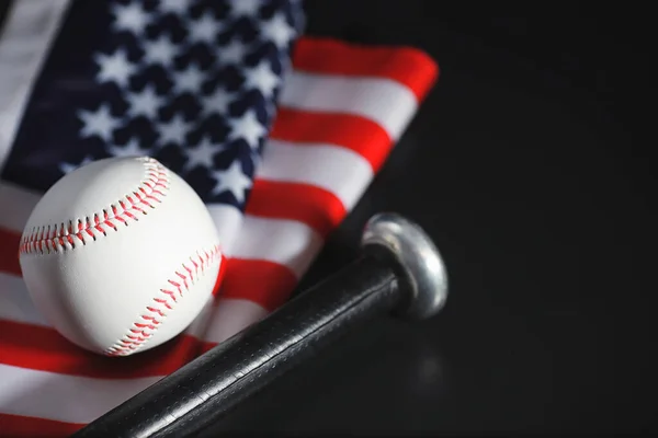 American traditional sports game. Baseball. Concept. Baseball ball and bats on table with american flag.