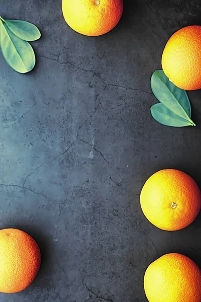 Orange citrus fruit on stone table. Orange background.