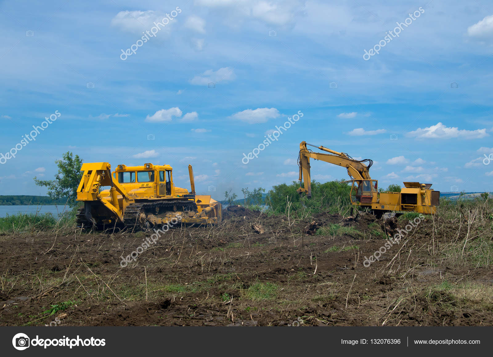 Excavator and bulldozer clearing forest land. Stock Photo by