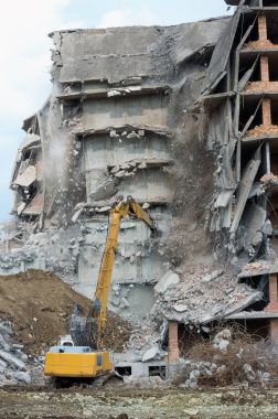 Tehlikeli bina bir kentsel alanda bir ekskavatör ile kaldırın.