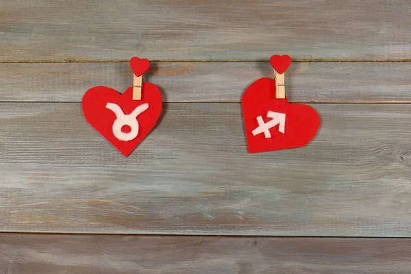 Taurus and Sagittarius. signs of the zodiac and heart. wooden ba — Stock Photo, Image