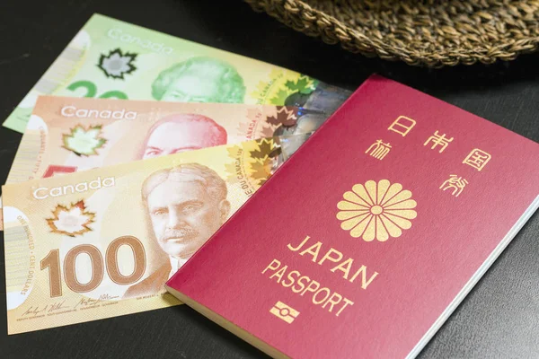 Dólar canadiense y pasaporte japonés — Foto de Stock