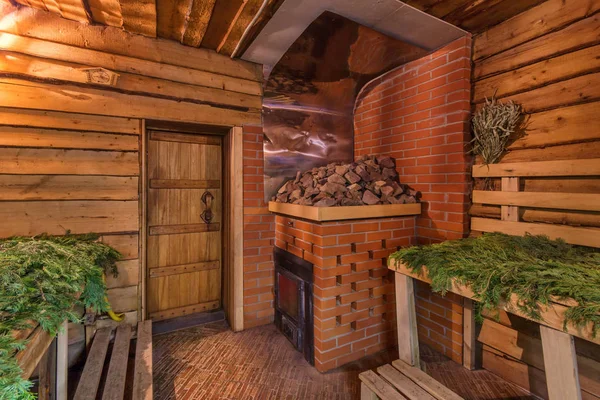 Rustic wood-burning sauna room with traditional sauna accessories — Stock Image Rustic wood-burning sauna room with traditional sauna accessories Stock Photo
