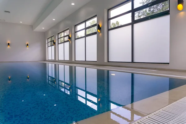 Indoor swimming pool of a modern house with spa