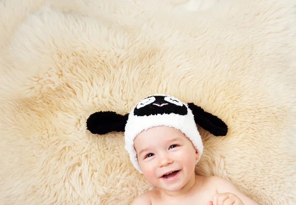 One year old baby lying in bunny hat on lamb wool — Stock Photo, Image