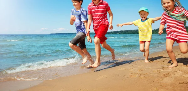 Šťastné děti na dovolené u moře běží ve vodě — Stock fotografie