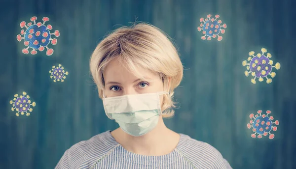 Молода жінка в медичній масці для захисту обличчя в приміщенні на синьому фоні — стокове фото