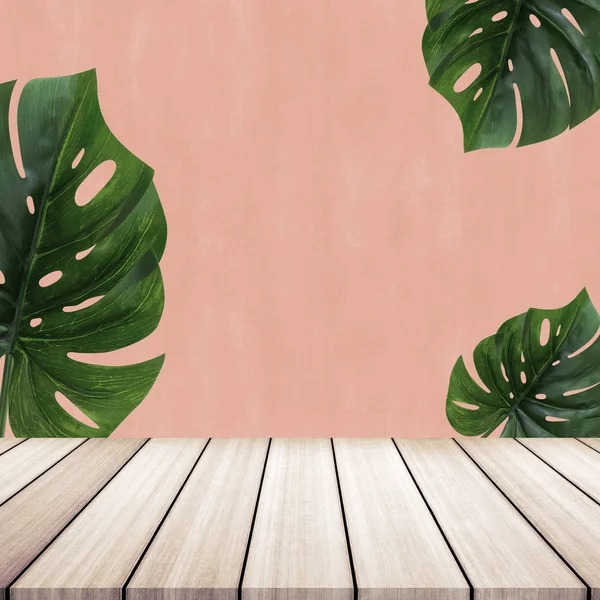 Mesa de madera con hojas de monstera de fondo . — Foto de Stock