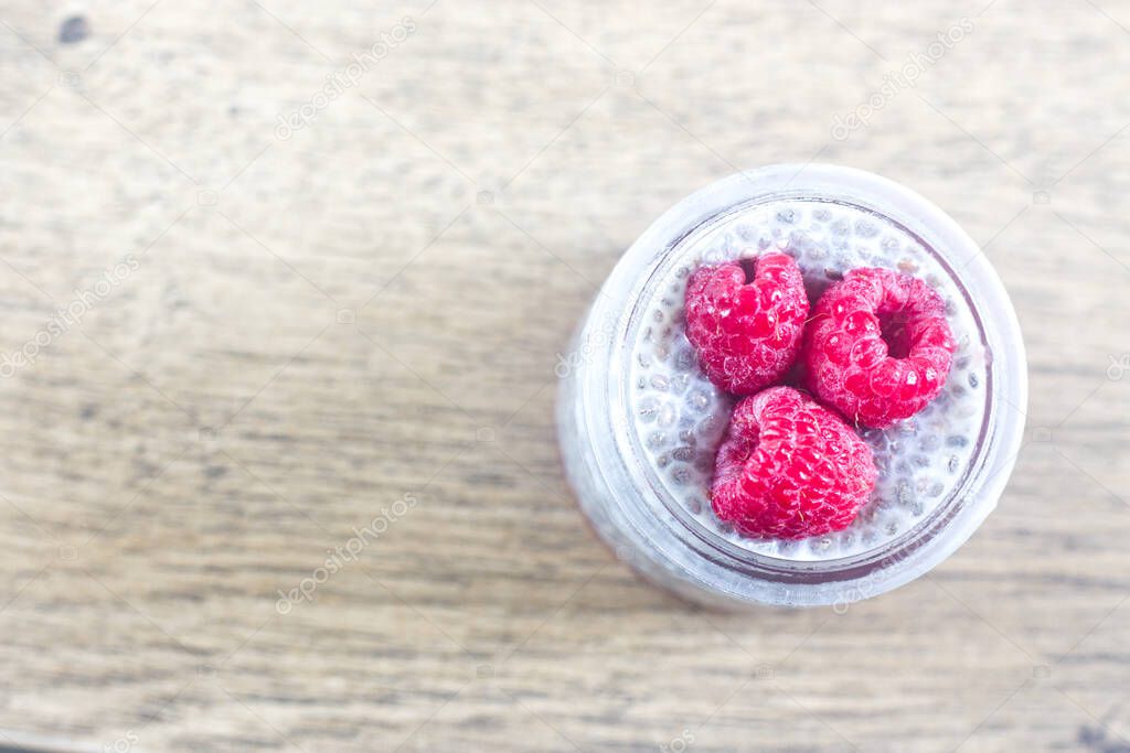 Photo of Homemade Chia Pudding with Raspberry in Transparent Glass.