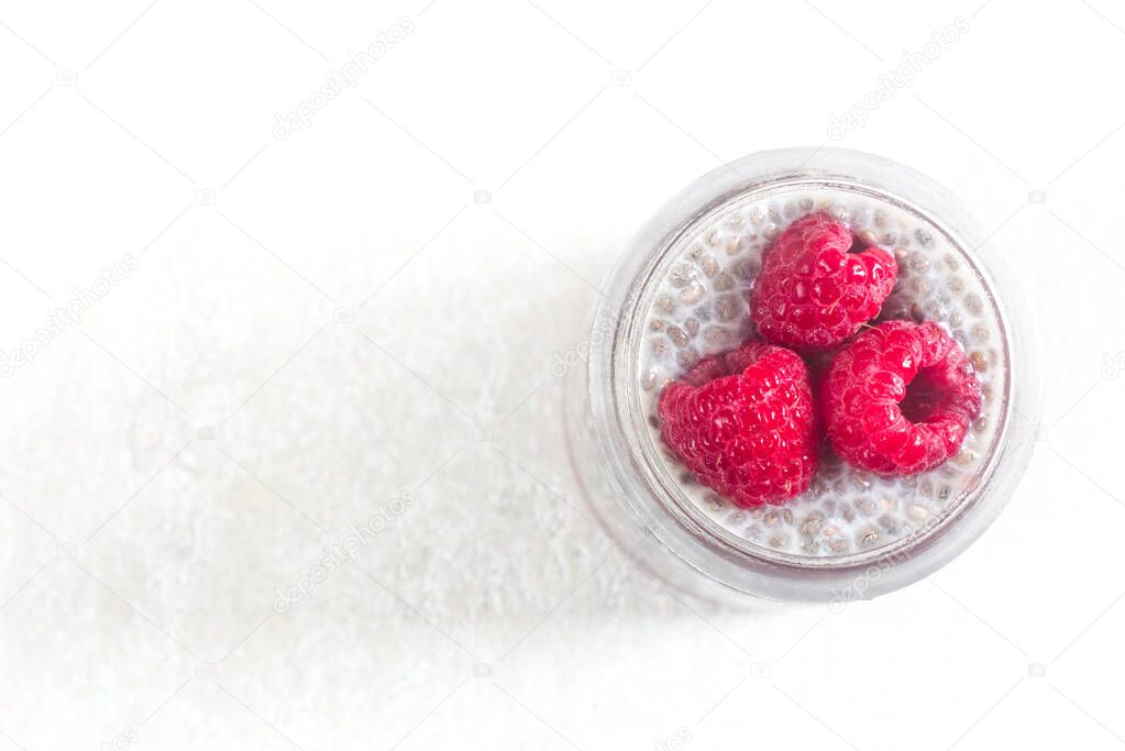 Photo of Homemade Chia Pudding with Raspberry in Transparent Glass.