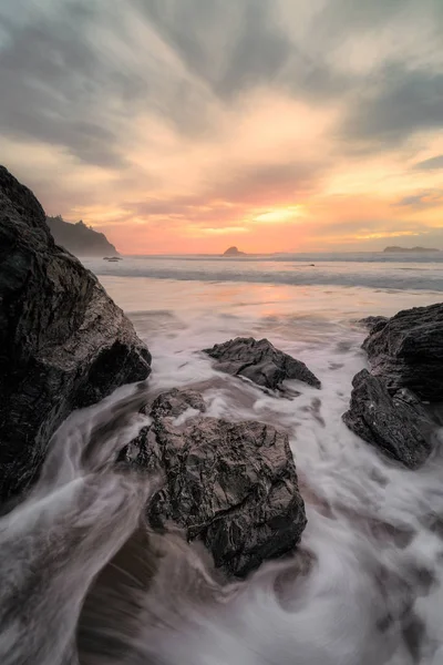 Atardecer en una playa rocosa tropical —  Fotos de Stock