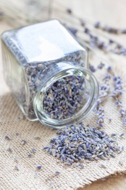 Cam jag ve ahşap zemin üzerinde kuru lavanta çayı, dikey