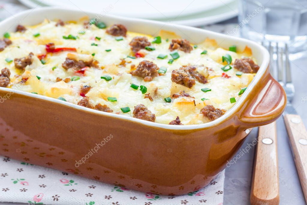 Egg casserole with potatoes, sausage and pepper, in baking dish, horizontal