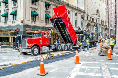 Workers repair the road at Boston, crossing of Tremont and Beacon streets, Massachusetts United States, 30 july 2017 clipart