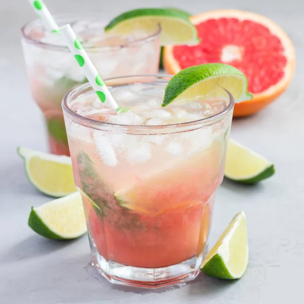 Cold Pink Cocktail Fresh Grapefruit Lime Ice Cubes Concrete Background — Stock Photo, Image