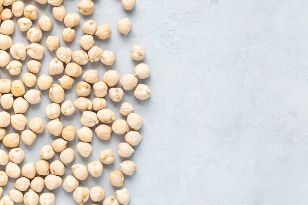 Uncooked dry chickpeas on concrete background, horizontal, copy space, closeup