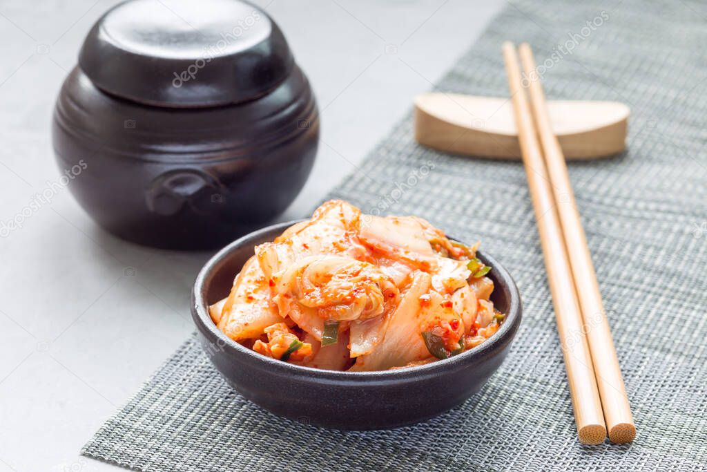 Kimchi cabbage. Korean appetizer in a ceramic bowl, horizontal