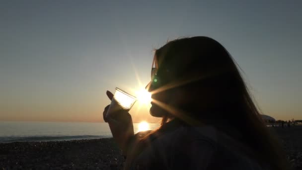 Νέα ελκυστική γυναίκα στην παραλία κατά το ηλιοβασίλεμα — Αρχείο Βίντεο