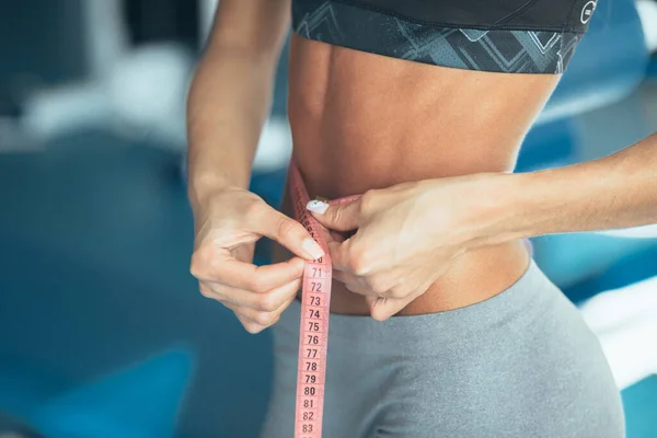 close up of perfect press abdomen.girl with perfect body holding bottle of water. healthy lifestyle concept . girl work out at home. sport waist. get fit. sport girl. Woman losing weight