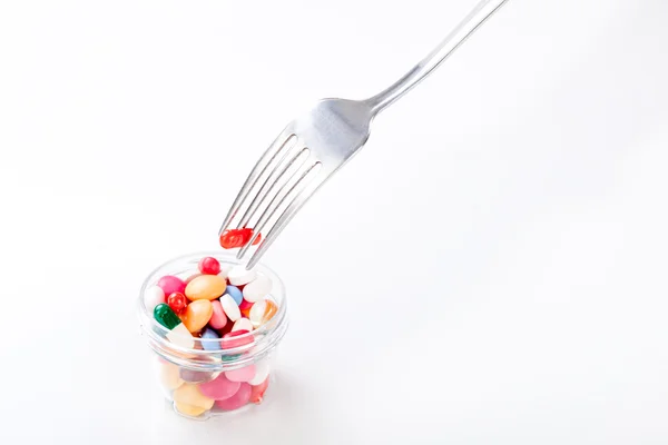 Drugs, medicine on a dish with fork, spoon — Stock Photo, Image