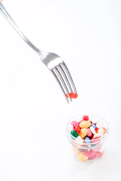 Drugs, medicine on a dish with fork, spoon — Stock Photo, Image