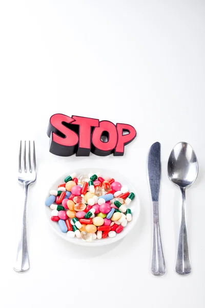 Drugs, medicine on a dish with fork, spoon — Stock Photo, Image