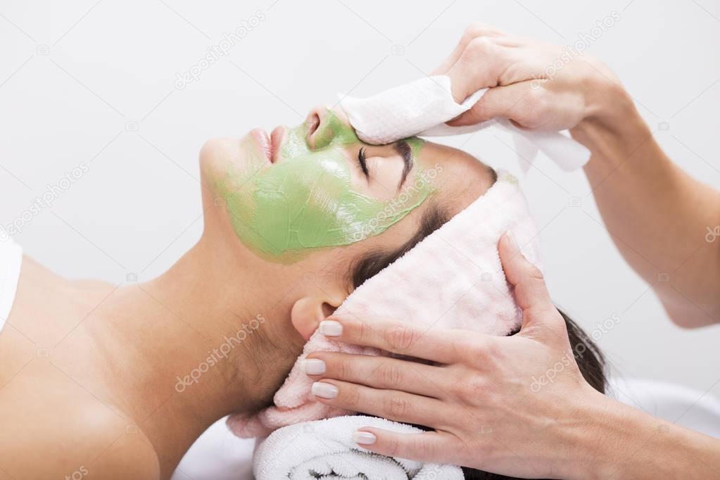 Young woman with algae facial mask