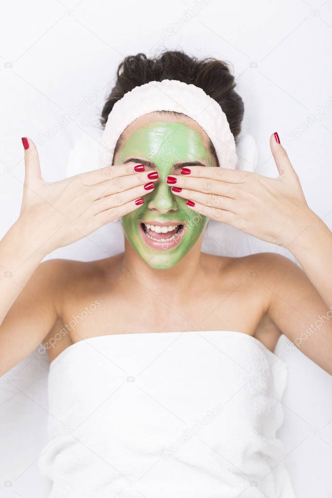 woman in a spa with algae facial mask