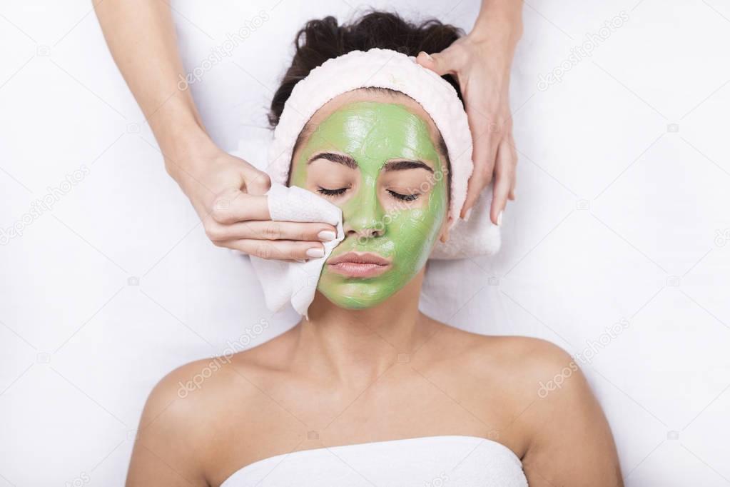 woman in a spa with algae facial mask