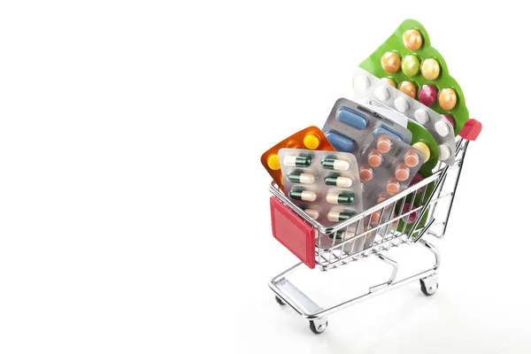 Colorful drugs and pills in a shopping cart — Stock Photo, Image