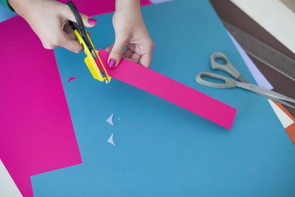 woman make scrapbook of the papers on the table