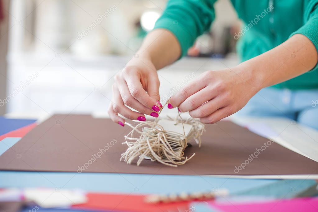 woman make scrapbook of the papers on the table