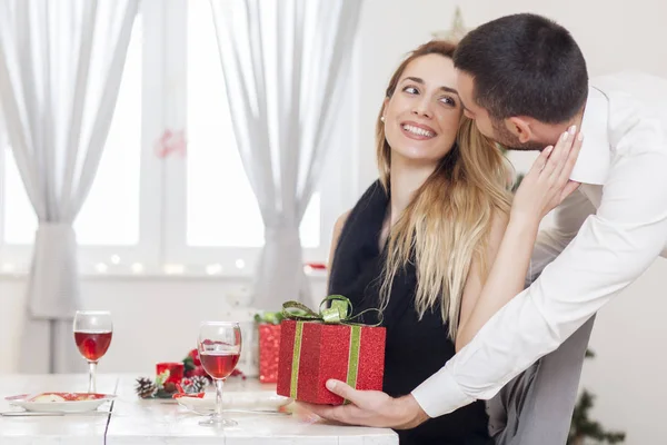 L'homme offre un cadeau à une femme la veille de Noël — Photo