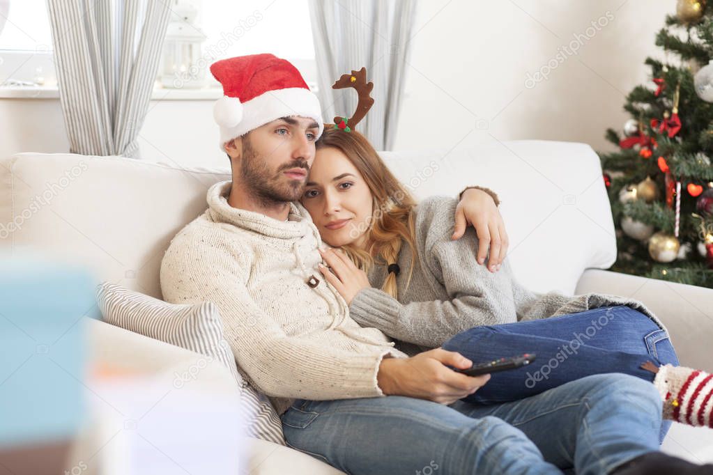couple in love on Christmas night watching TV