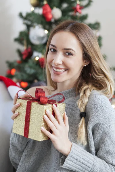 woman with christmas box gift in front