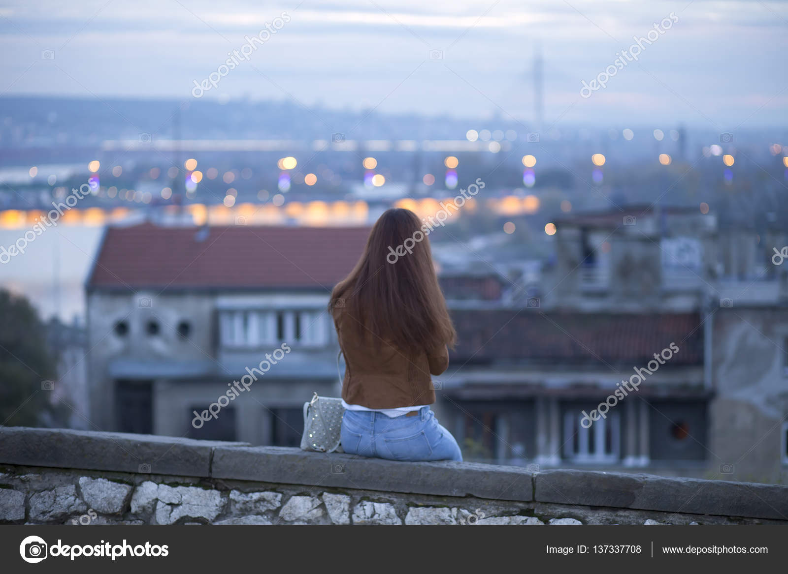 Young Sad Woman Sitting Alone On A Wall And Looking At The Panorama Of The City Lonely Women Stock Photo Image By C Nikodash