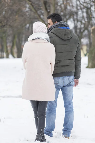 couple hugging and laughing outdoors in winter