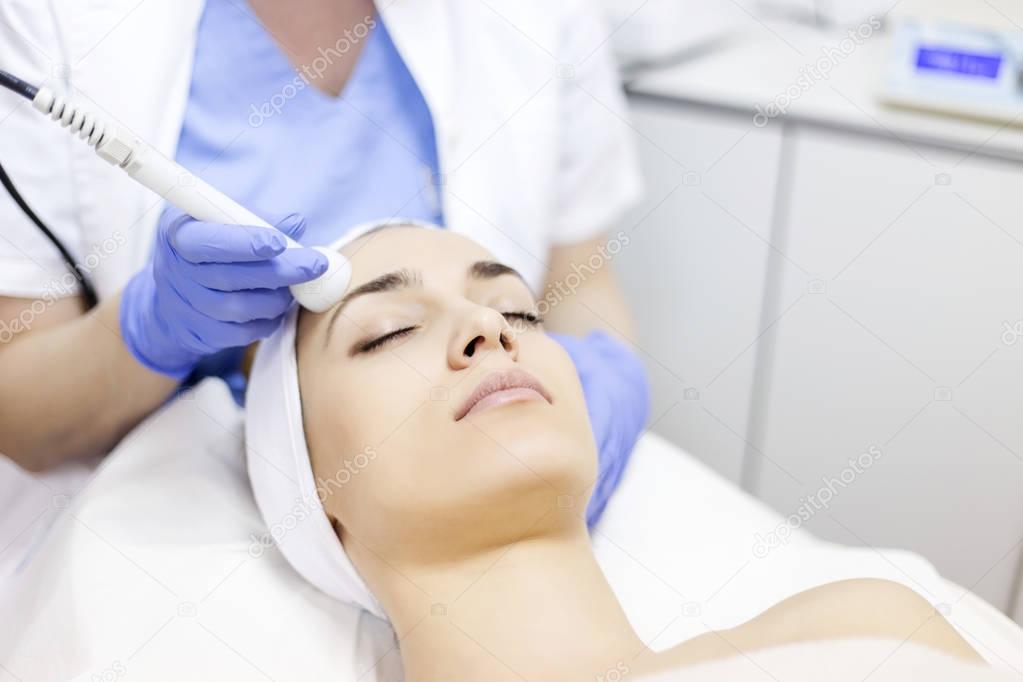 woman receiving facial beauty treatment