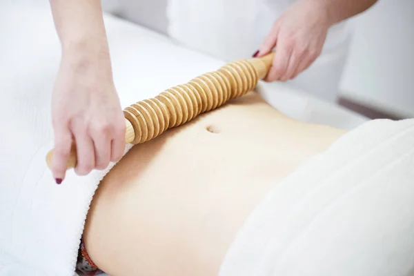 Anti cellulite massage for woman with rolling pins — Stock Photo, Image