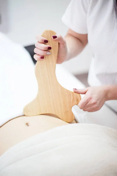 Anti cellulite massage for woman with rolling pins — Stock Photo, Image